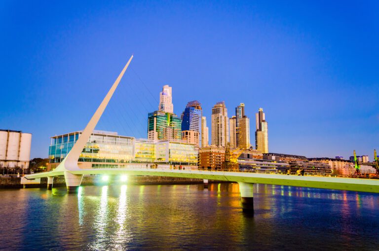Women's Bridge and upscale skyscrapers at night in Puerto Madero neighborhood of Buenos Aires